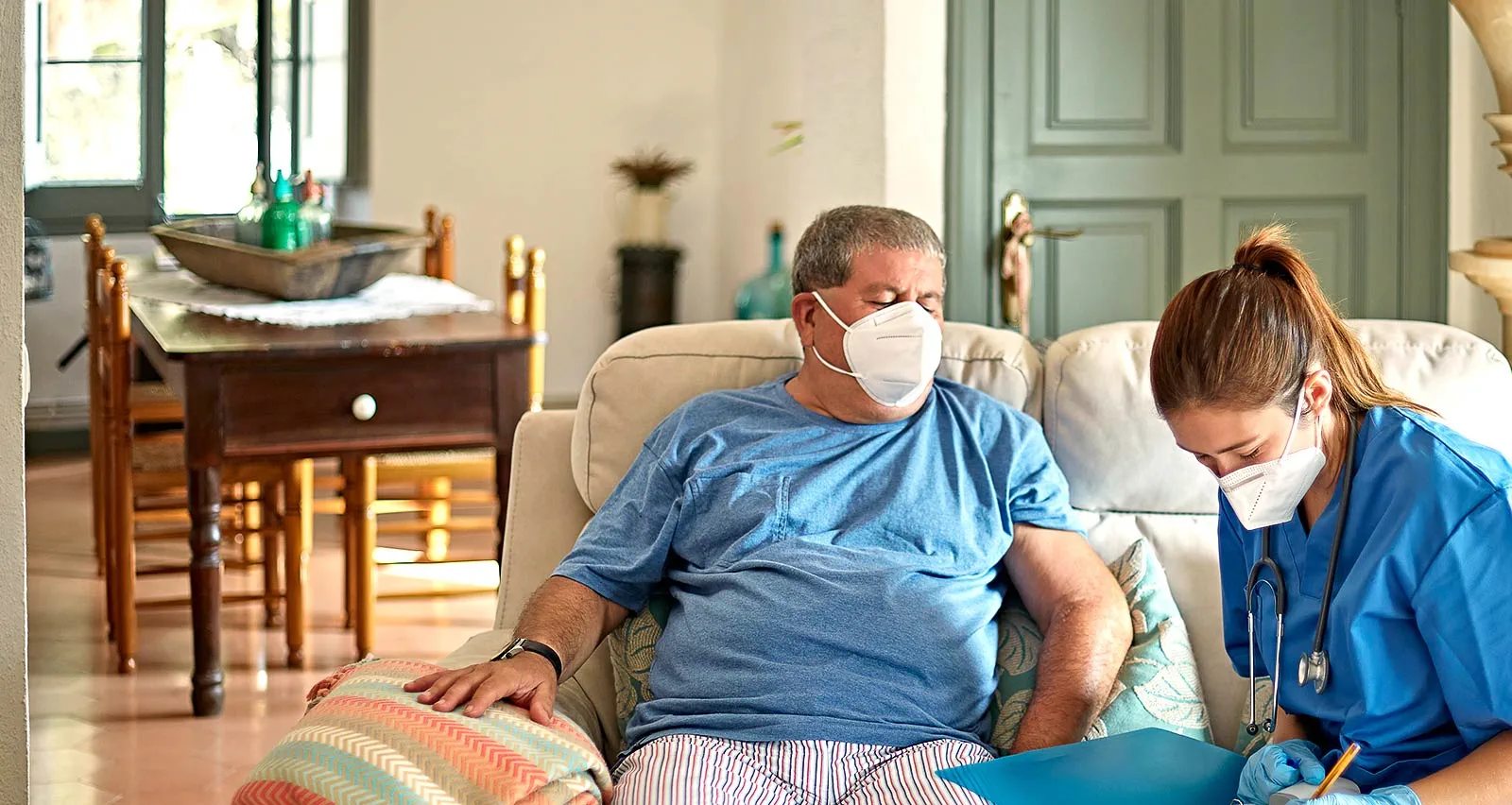 A THRYVE clinician attending to a patient during a scheduled visit at home